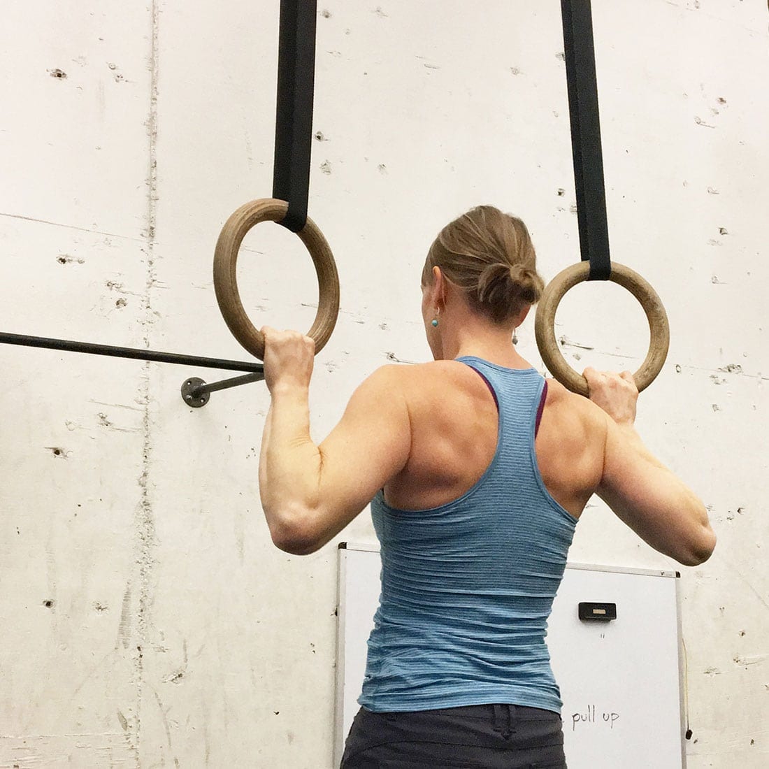 woman working out with gym rings