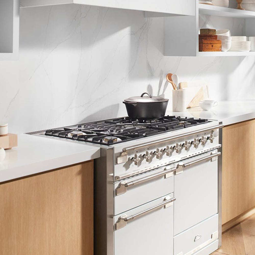 white and tan kitchen with marble backsplash